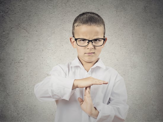 Closeup portrait serious young man, child, making, showing time out gesture with hands, isolated grey wall background. Negative human emotions, facial expressions, feeling, signs symbol body language