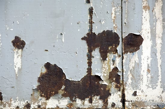 Detail of weather-beaten wall by a city street -- urban grunge