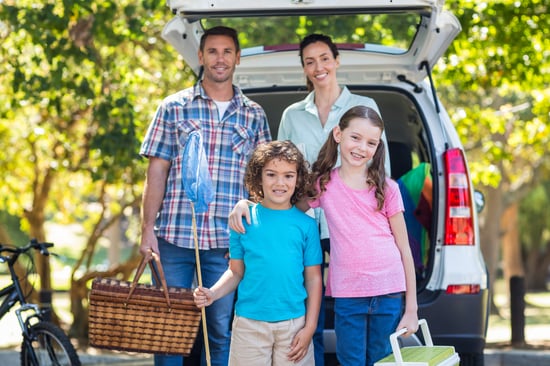 Happy family getting ready for road trip on a sunny day
