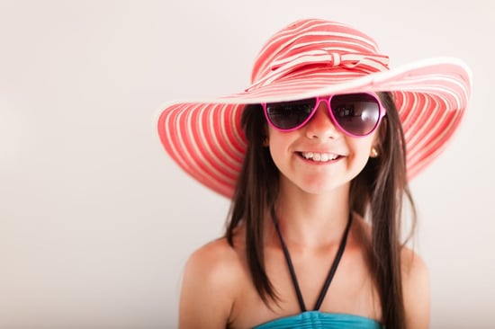 Happy summery girl wearing a hat and sunglasses