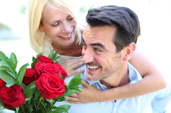 Man giving red roses to woman