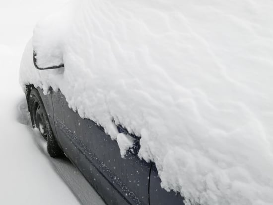 Winter at a glance Top of car buried in snow during a storm