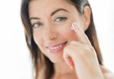 Woman in her forties applying  face cream